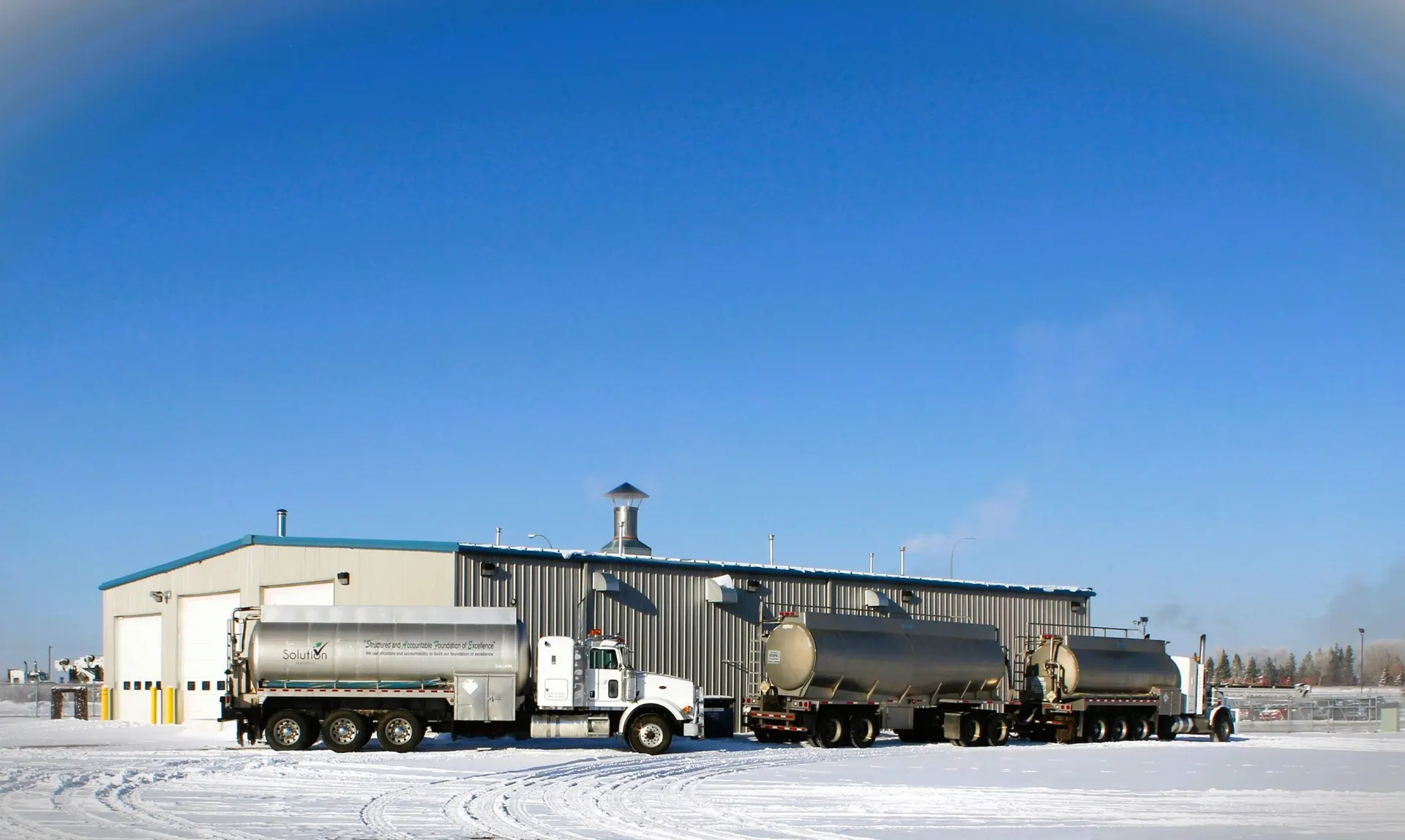Tanker trucks loading at the Absolute Fluids bulk water station in Clairmont, near Grande Prairie